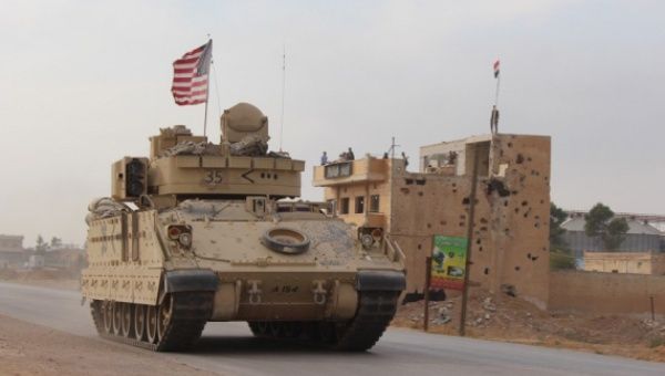 A U.S. military vehicle is seen passing through the Tal Tamr area in the countryside of Hasakah Province in northeastern Syria on Nov. 14, 2019.