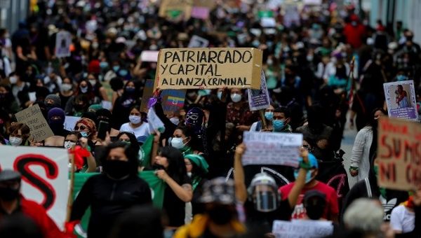 Women's rights activists mobilize in Quito, Ecuador, March 7, 2021. The sign reads, 