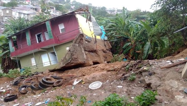 Heavy rains cause a house to slide in Santiago, Dominican Republic, March 9, 2021.