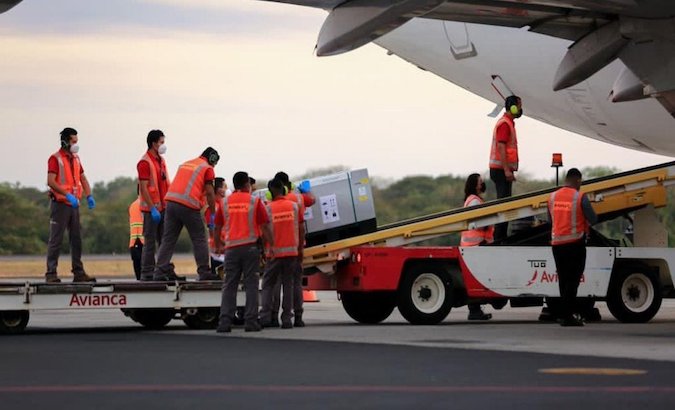 Airport workers unload batch of vaccines, San Salvador, El Salvador, March 11, 2021.