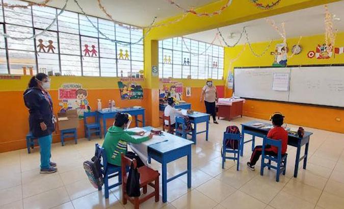 Children receive classes at a school in Lima, Peru.