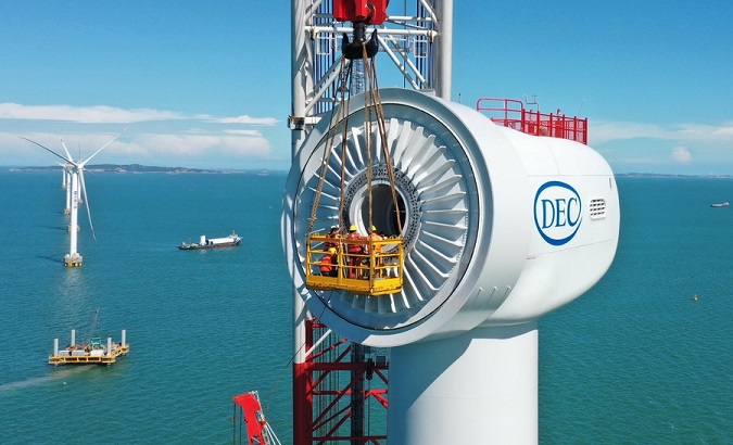 Workers installing an offshore wind turbine at a wind farm, Fuqing, China, June 12, 2020.
