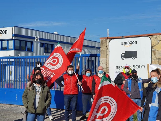 Amazon workers demonstrate outside of the warehouse in Tuscany on March 22, 2021.