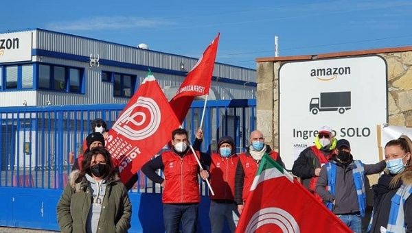 Amazon workers demonstrate outside of the warehouse in Tuscany on March 22, 2021.