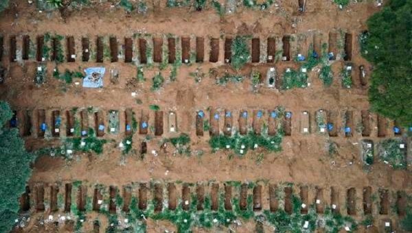 Aerial shot depicts digging of mass graves in Brazil as death toll spikes.