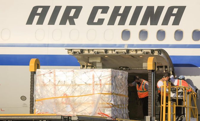 Airport workers unload Sinovac doses from an AirChina aircraft in San Salvador, El Salvador, March 28, 2021.