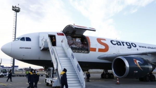 Workers prepare to unload the COVID-19 vaccine at the Tbilisi international airport in Tbilisi, Georgia, March 13, 2021, when Georgia received its first batch of 43,200 doses of a COVID-19 vaccine via the COVAX platform