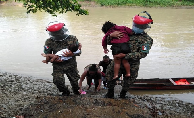 Rescuers transfer a migrant family to the Meteti Medical Center in Darien, Panama, Apr. 16, 2021.