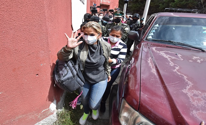 Jeanine Añez (C) enters the Obrajes Women's Guidance Center, La Paz, Bolivia, March. 15, 2021.