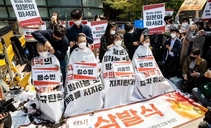 Students shave their hair in protest in front of Japan’s embassy, Seoul, South Korea, April 20, 2021.