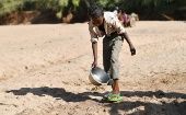A boy washes his feet on the dried-up riverbed near Doolow, a border town with Ethiopia, Somalia. 