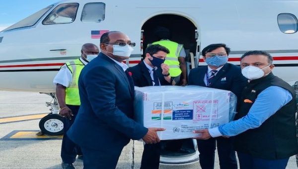 Prime Minister Gaston Browne (left) accepts vaccines from India at the VC Bird International Airport in Antigua 