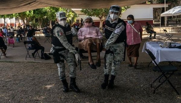 Police Officers help in a vaccination Center for elders, Valley of Mexico, Ecatepec, May 1, 2021.