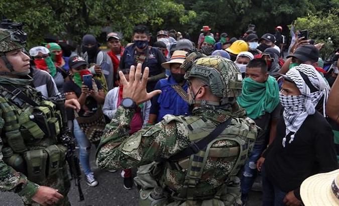 Soldiers stop the Indigenous march in Cali, Colombia, May 9, 2021.