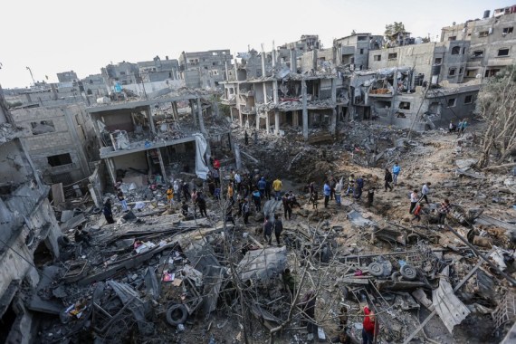Palestinians inspect their destroyed houses in the northern Gaza Strip town of Beit Hanoun, on May 14, 2021.
