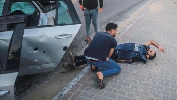 Journalist lies on the ground after an Israeli attack, Gaza, May 17, 2021.