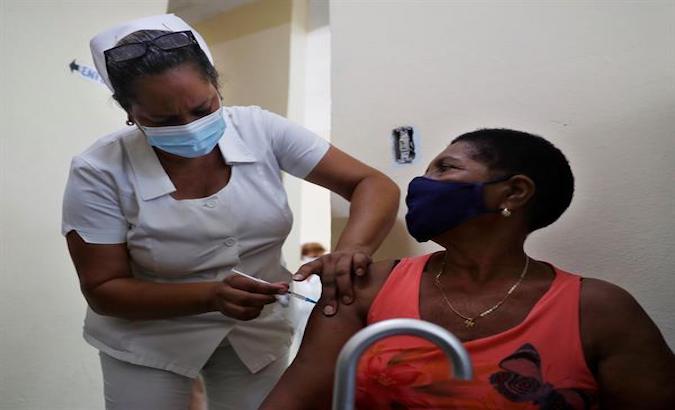 A health worker vaccinates a patient in Havana, Cuba, May 2021.