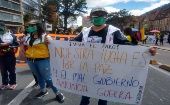 The sign reads, "Our struggle is for peace, but the government declares war," Bogota, Colombia, May 2021.