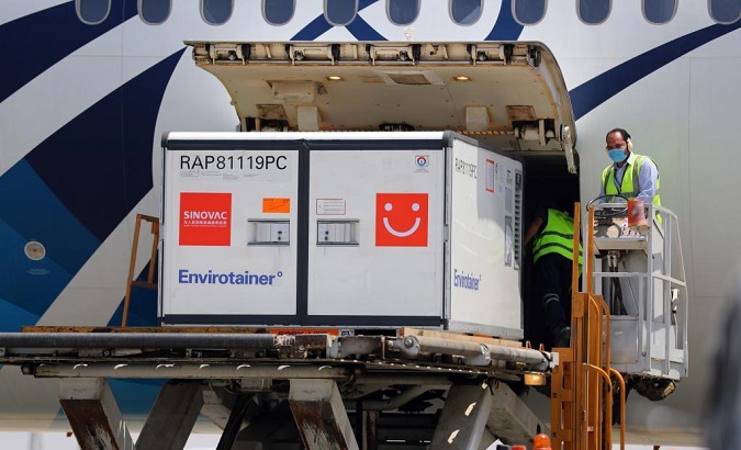 Airport staff members unload the first batch of Sinovac vaccine raw materials, Cairo, Egypt, May 21, 2021.
