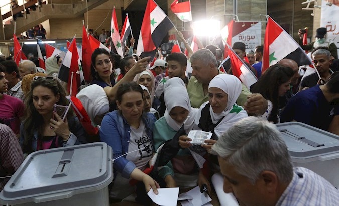 Citizens cast their votes at a polling booth, Damascus, Syria, May 26, 2021.