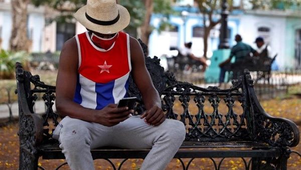 A man uses his phone in a park in Havana, Cuba, May 6, 2021.