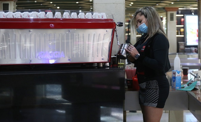 A waitress prepares cups of coffee, Santiago, Chile, Sept. 20, 2020.