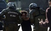Police officers detain a protester during a demonstration in Santiago Chile, Nov. 18, 2020.