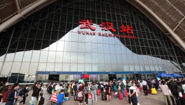Passengers walk into Wuhan Railway Station in Wuhan, capital of central China's Hubei Province, May 5, 2021.