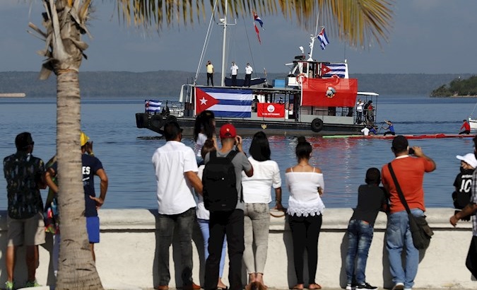 People watch the race against the US blockade in Cienfuegos City, Cuba, May 30, 2021.