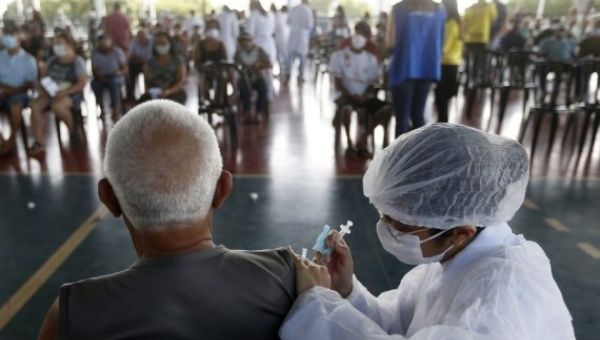 A senior citizen receives a dose of Chinese-developed COVID-19 vaccine in Brasilia, Brazil, on March 22, 2021.