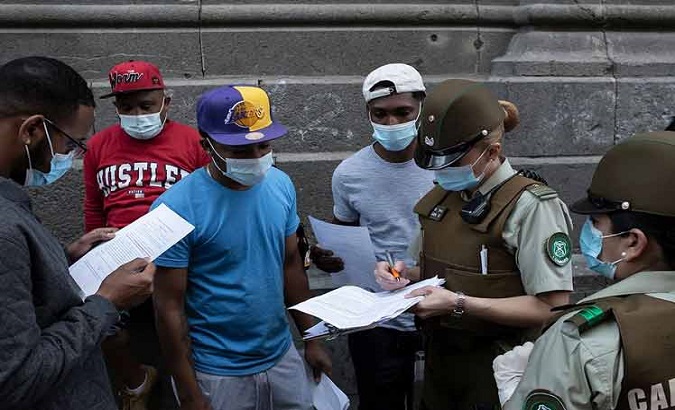 Police officers checking migrants' documentation in Chile, June 6, 2021.