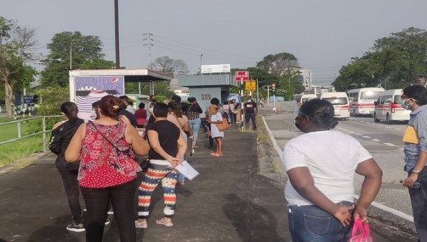 Citizens wait outside St. Joseph Enhanced Health Center to get a COVID-19 vaccine, Trinidad & Tobago, June 9, 2021.