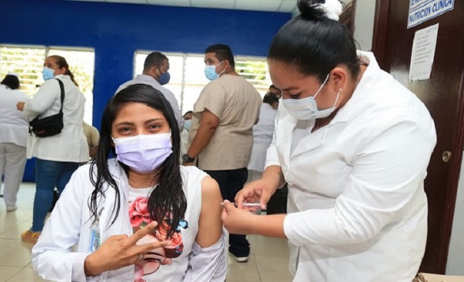Nurse makes the victory sign while receiving a COVID-19 vaccine, Nicaragua, May 3, 2021.