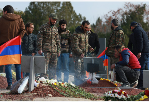 People bury the fallen soldiers killed in the Nagorno-Karabakh conflict in Yerevan, Armenia, Nov. 20, 2020.