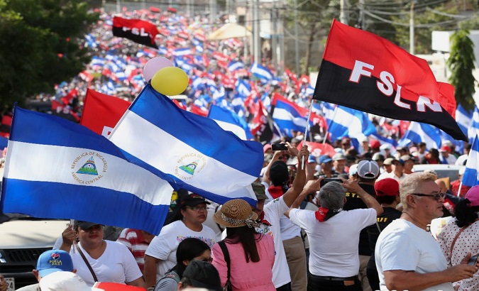Supporters of the Sandinista National Liberation Front (FSLN) march in Managua, Nicaragua, Jan. 11, 2021.