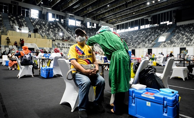 A health worker receives a Sinovac COVID-19 vaccine in Jakarta, Indonesia, Feb. 4, 2021.