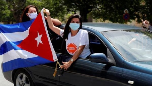 Citizens wave the Cuban flag during a car convoy against the U.S. blockade, Havana, Cuba, June 23, 2021.