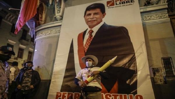 A Pedro Castillo’s supporter poses with his image at his party’s headquarters,Lima, Peru,June 15, 2021