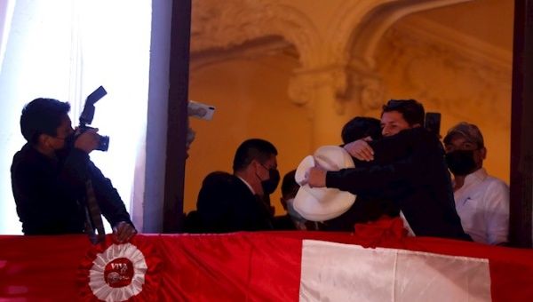 The leftist Pedro Castillo (r), embraces his formula to the Vice President Dina Boluarte, during an appearance from a balcony after being proclaimed president-elect of the country today, in Lima