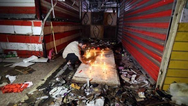 A man lights up candles at the site of a bomb explosion in Baghdad, Iraq, on July 19, 2021. 