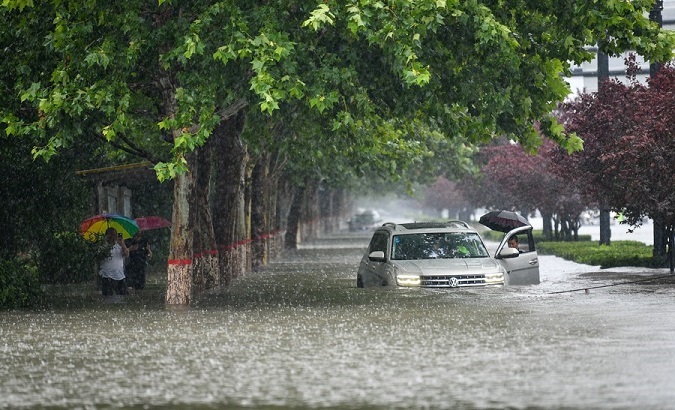 A car is inundated by rainwater in Zhengzhou, China, July 20, 2021.