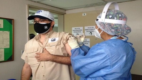 A man receives a dose of a COVID-19 vaccine, Venezuela. 