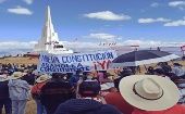 Citizens hold a banner saying, "New constitution, constituent assembly now", Pampa de la Quinua, Ayacucho, Peru, July 29, 2021.
