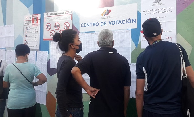 People look at a voting list, Venezuela, Aug. 8, 2021.