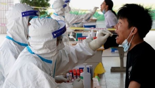 Medical workers take swab samples for COVID-19 tests at a testing site in Jinshui District of Zhengzhou, central China's Henan Province, Aug. 2, 2021.