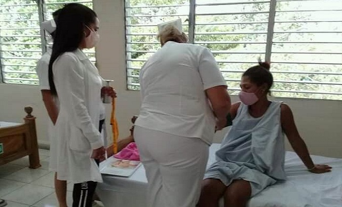 Nurses take the blood pressure of a pregnant woman in a maternal home, Cienfuegos, Cuba, 2021.