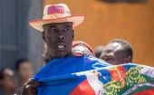 Citizen holds the Haitian flag.