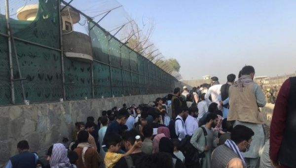 Afghans gather near a gate of Kabul airport in Kabul, Afghanistan, Aug. 22, 2021.