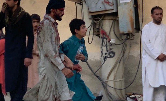 Injured people flee the blast site, Kabul, Afghanistan, Aug. 26, 2021.