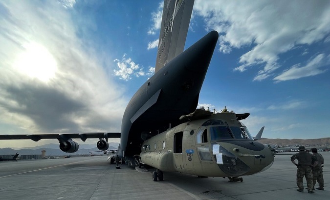 A CH-47 Chinook is loaded onto a U.S. Air Force C-17 Globemaster III, Afghanistan, Aug. 28, 2021.